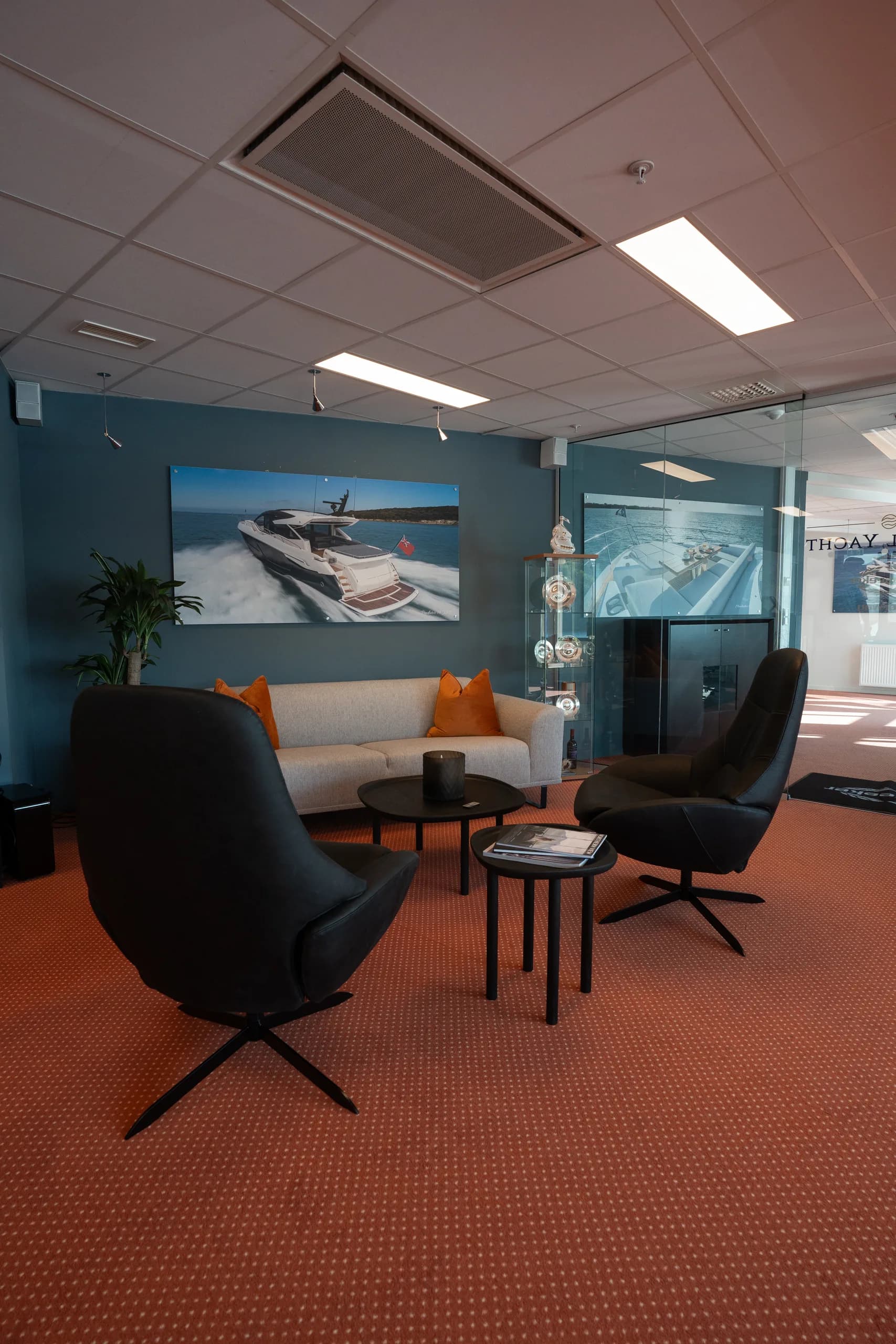 Loungeområdet hos Sundal Yacht med Sunseeker-bilde på veggen.
